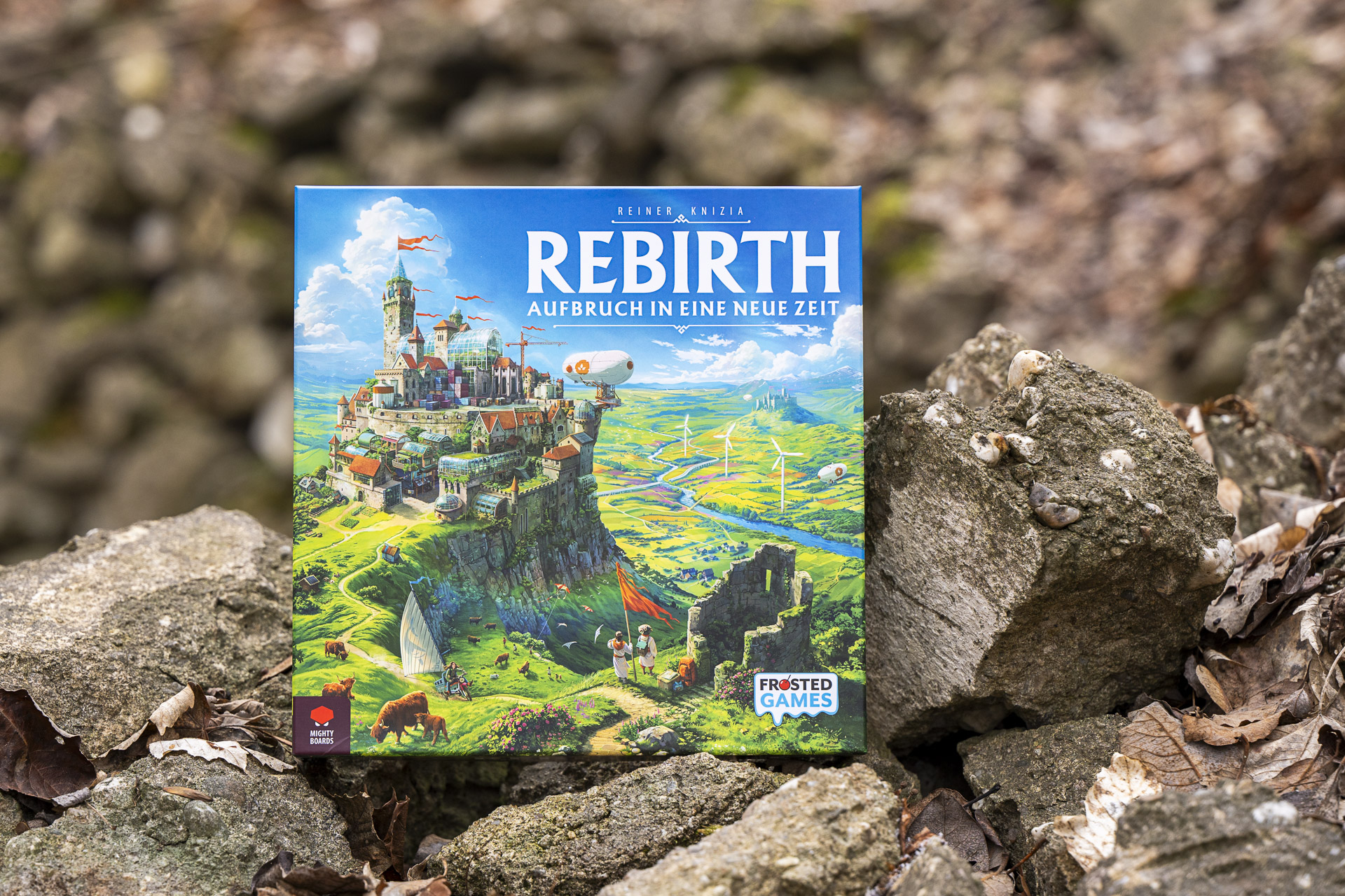 The German edition of Rebirth: Aufbruch in eine neue Zeit photographed outdoors on rocks.