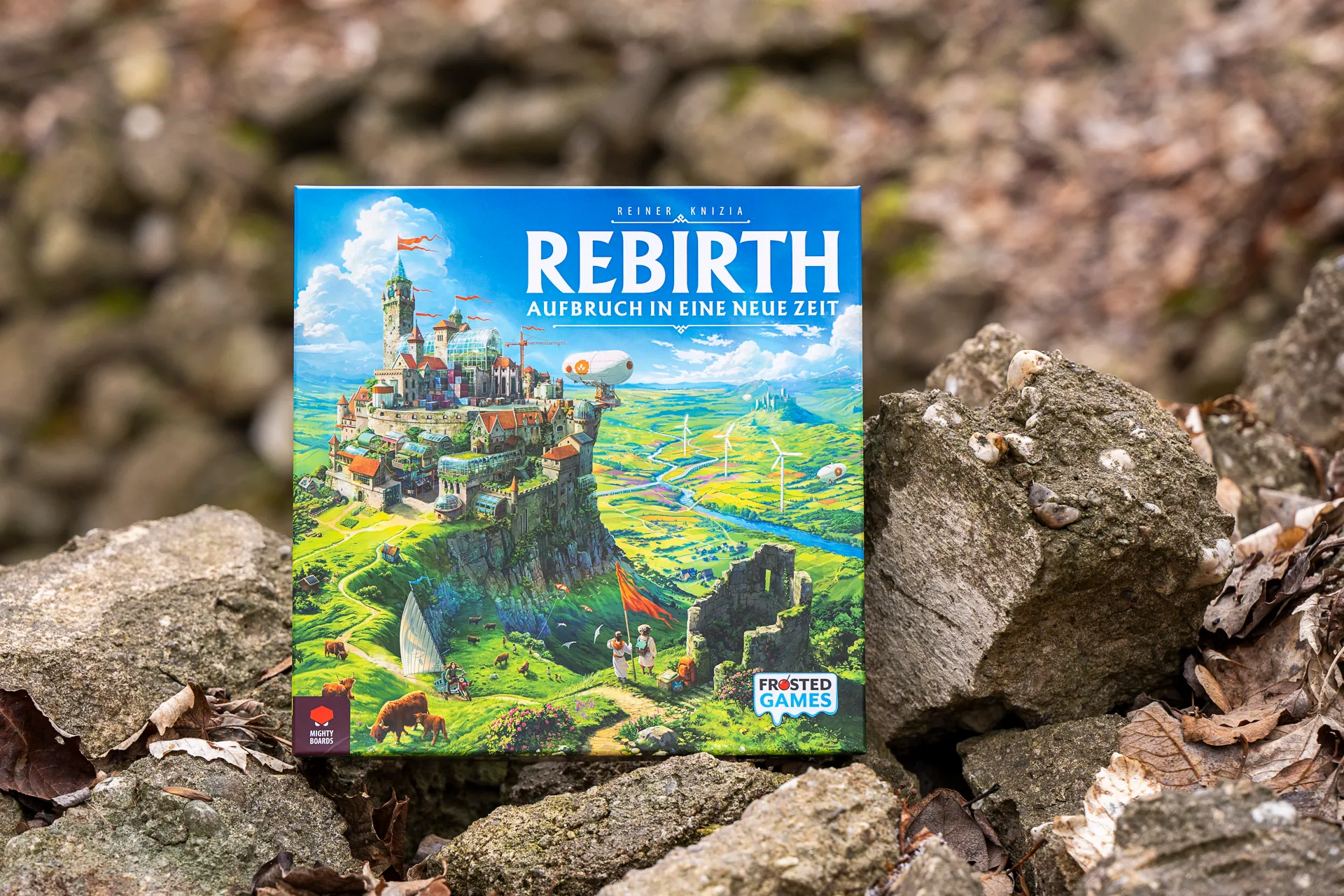 The German edition of Rebirth: Aufbruch in eine neue Zeit photographed outdoors on rocks.