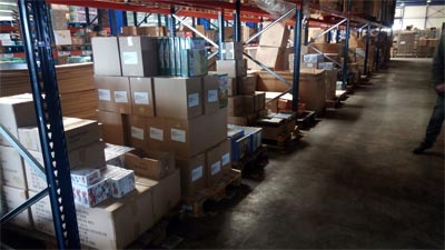 Official Atalia warehouse image from the company's about page, showing shelves and stock for board-game distribution.