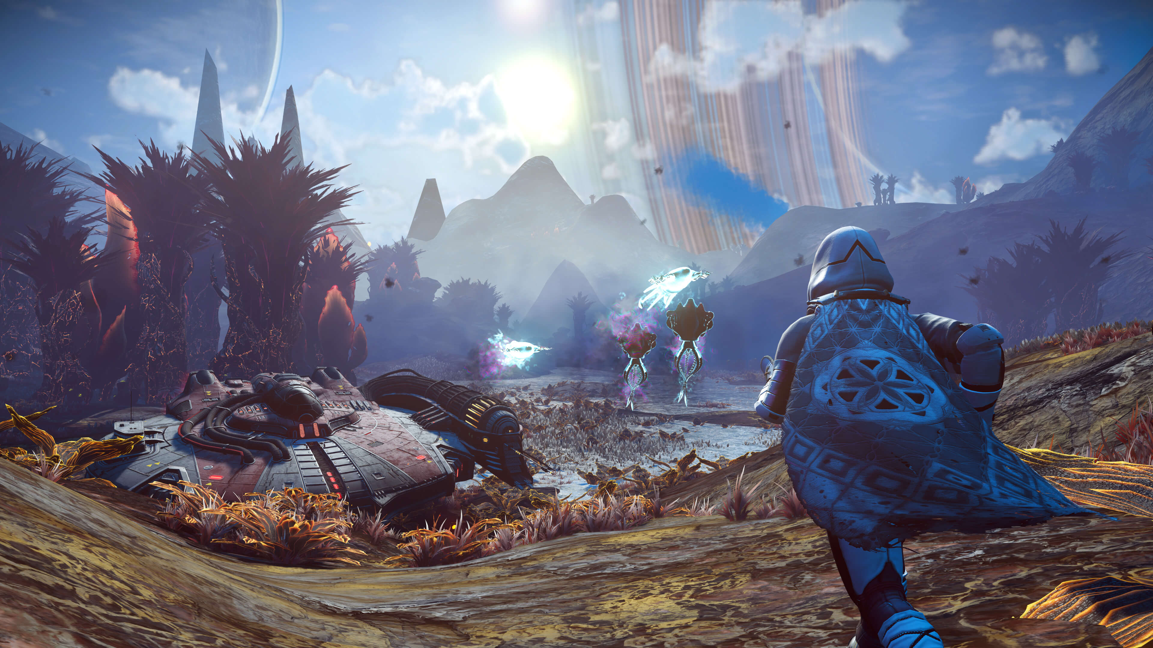 A hooded traveller faces glowing creatures beside a landed craft, with a ringed planet above the landscape.