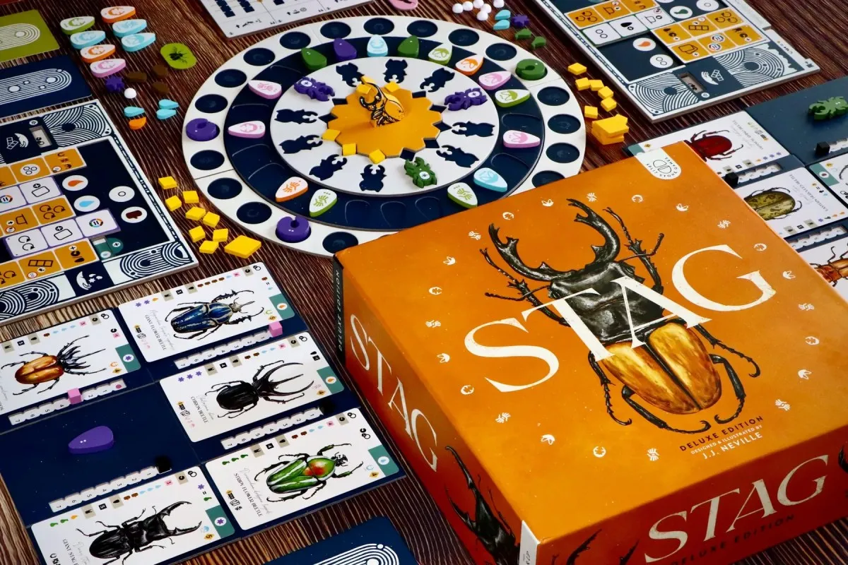 STAG board game prototype photo from Tabletopping showing beetle-themed boards, cards, and wooden pieces.