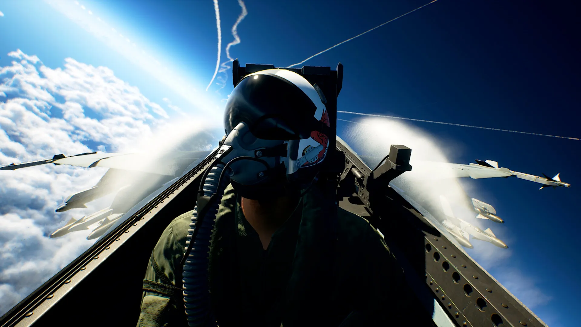 A helmeted pilot in a fighter cockpit, with missiles beneath the wings and clouds behind.