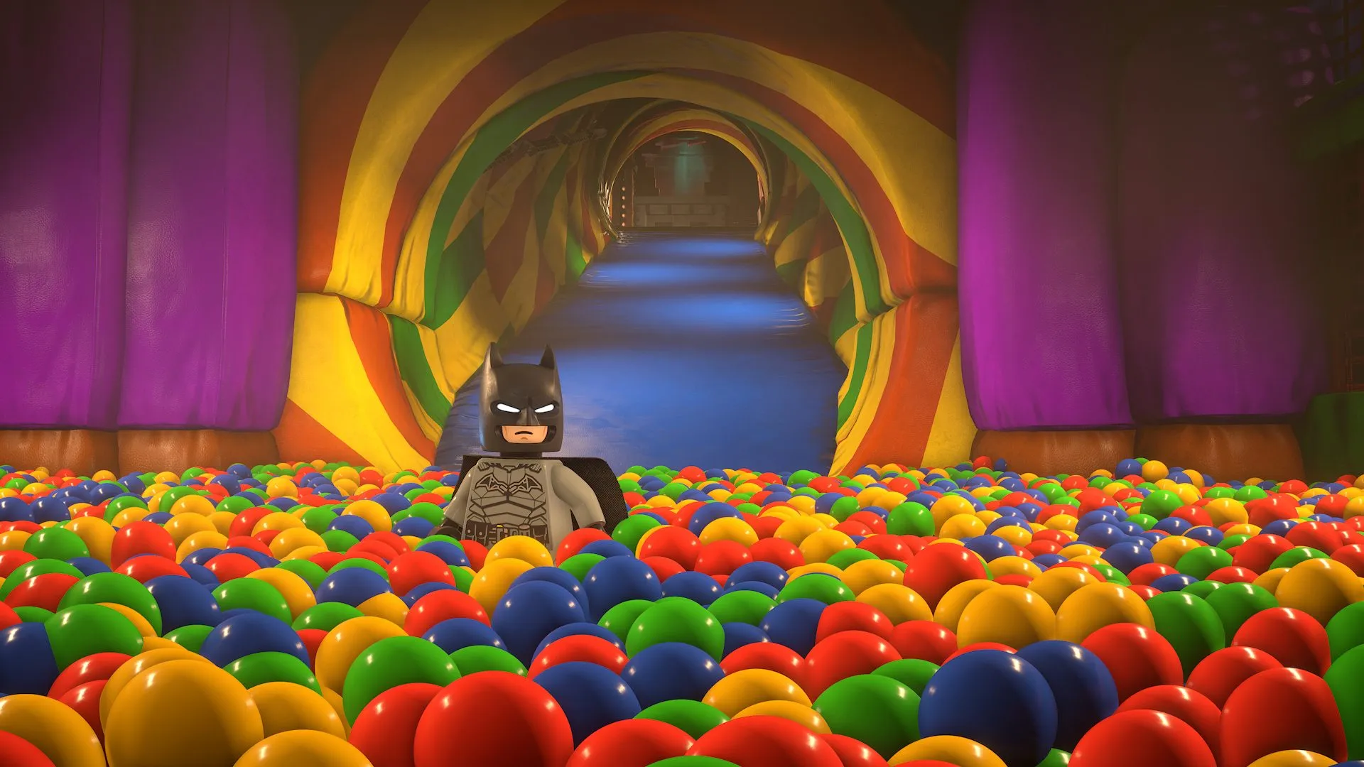 Official LEGO Batman image from PlayStation Blog showing Batman standing in a colorful ball pit during the hands-on preview.