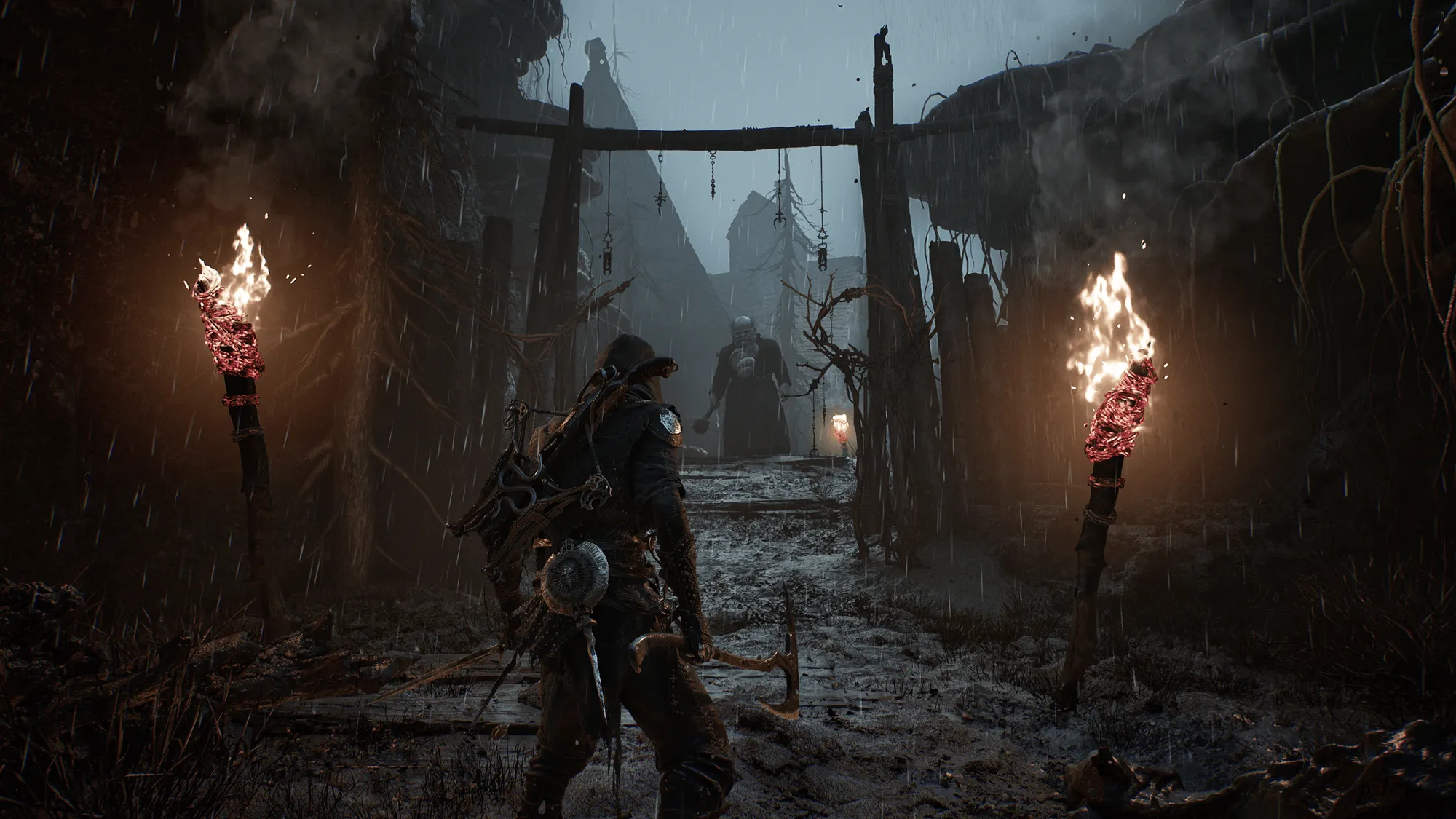 Official Mortal Shell II screenshot showing the Harbinger facing a large enemy in a rain-soaked corridor lit by burning torches.