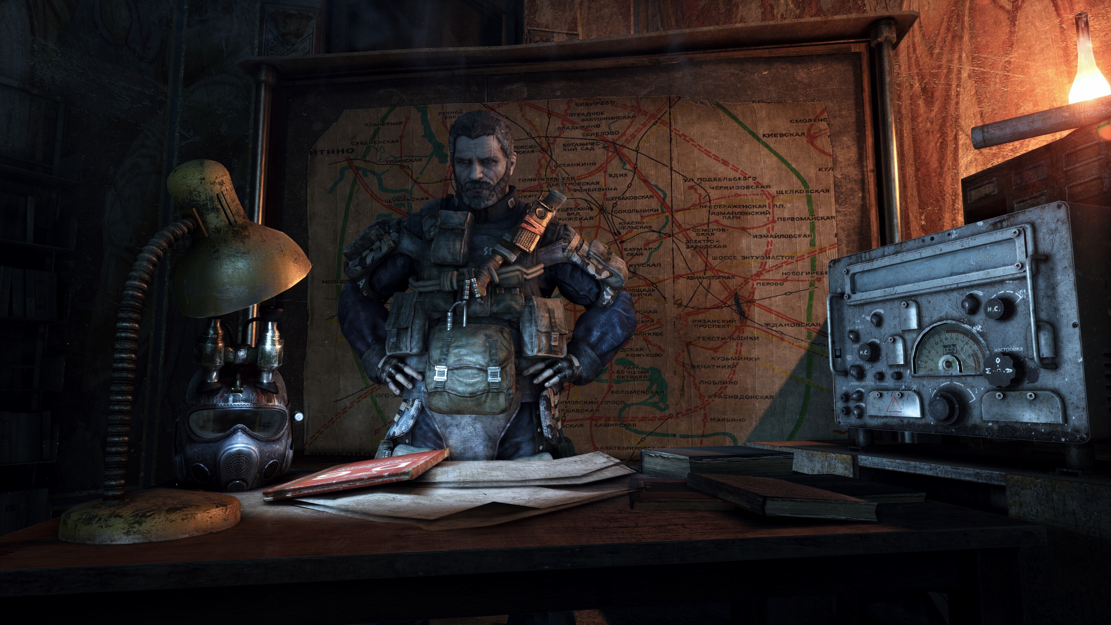 An armored man stands behind a desk in Metro 2033 Redux, with a metro map and radio beside him.