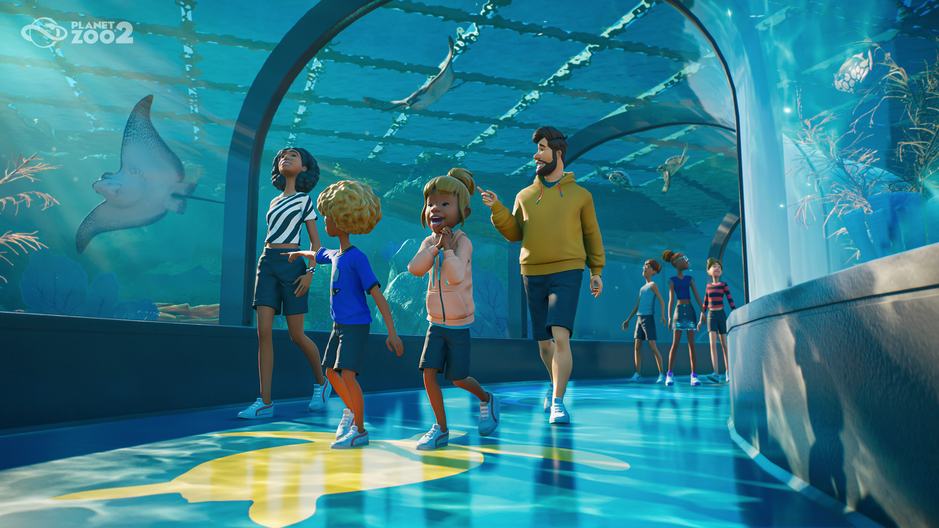 Visitors walk through a glass aquarium tunnel beneath aquatic animals.