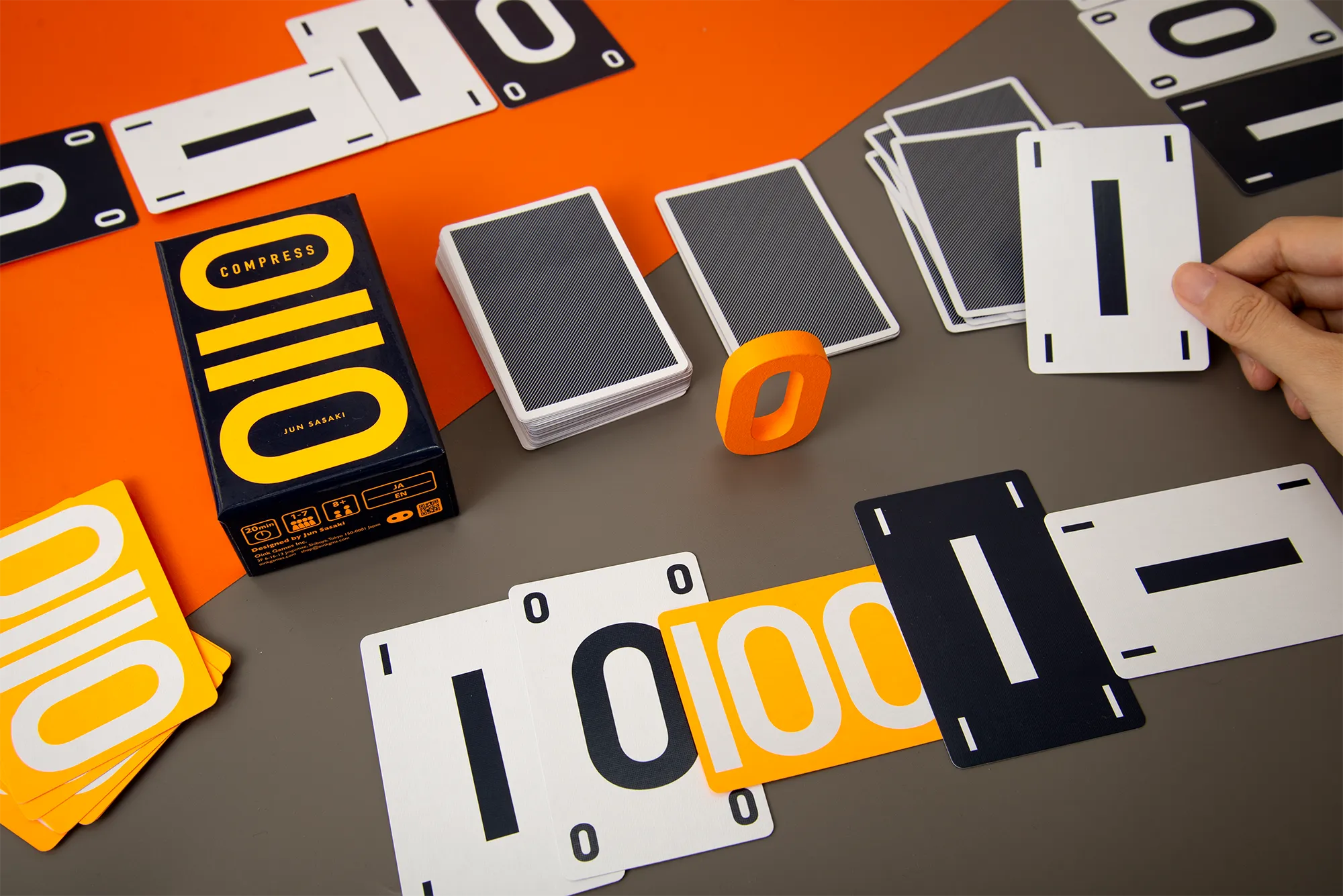 Compress cards showing black and white zeroes and ones arranged beside the game box.