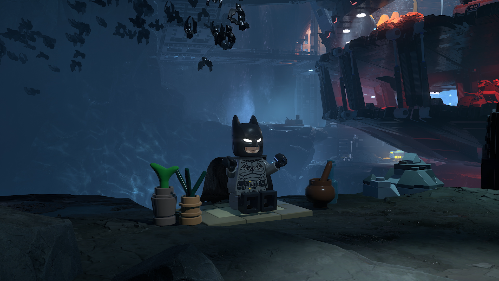 Official LEGO Batman screenshot from PlayStation showing the Batcave customization and trophy-heavy hub presentation.