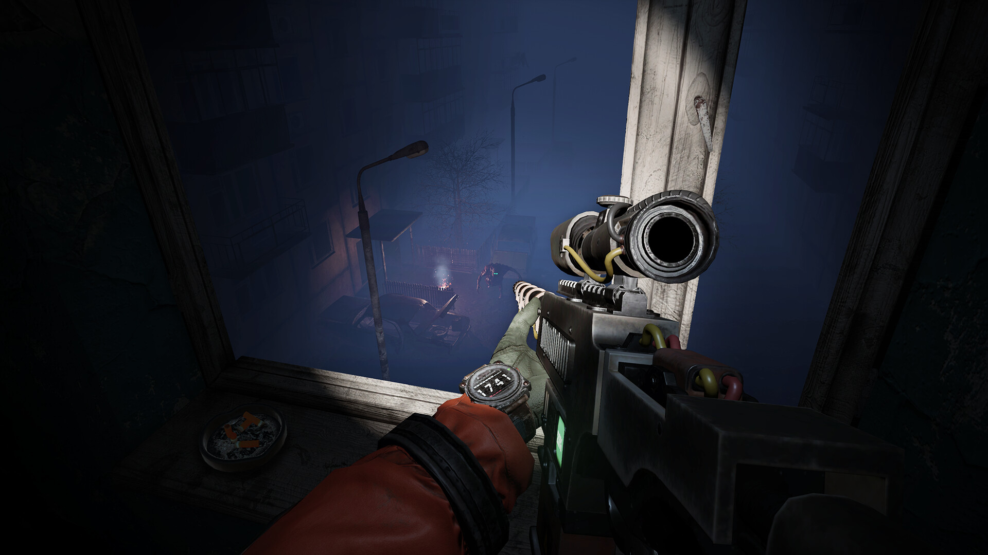 Scoped rifle looking down from a window onto a dark city street.