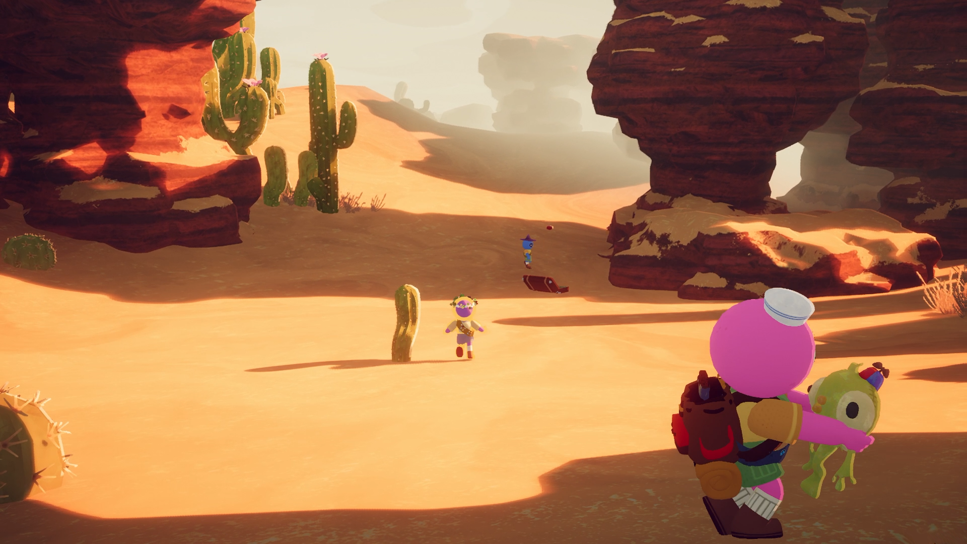 A pink scout holds a green creature while two other scouts move through a cactus-lined canyon.